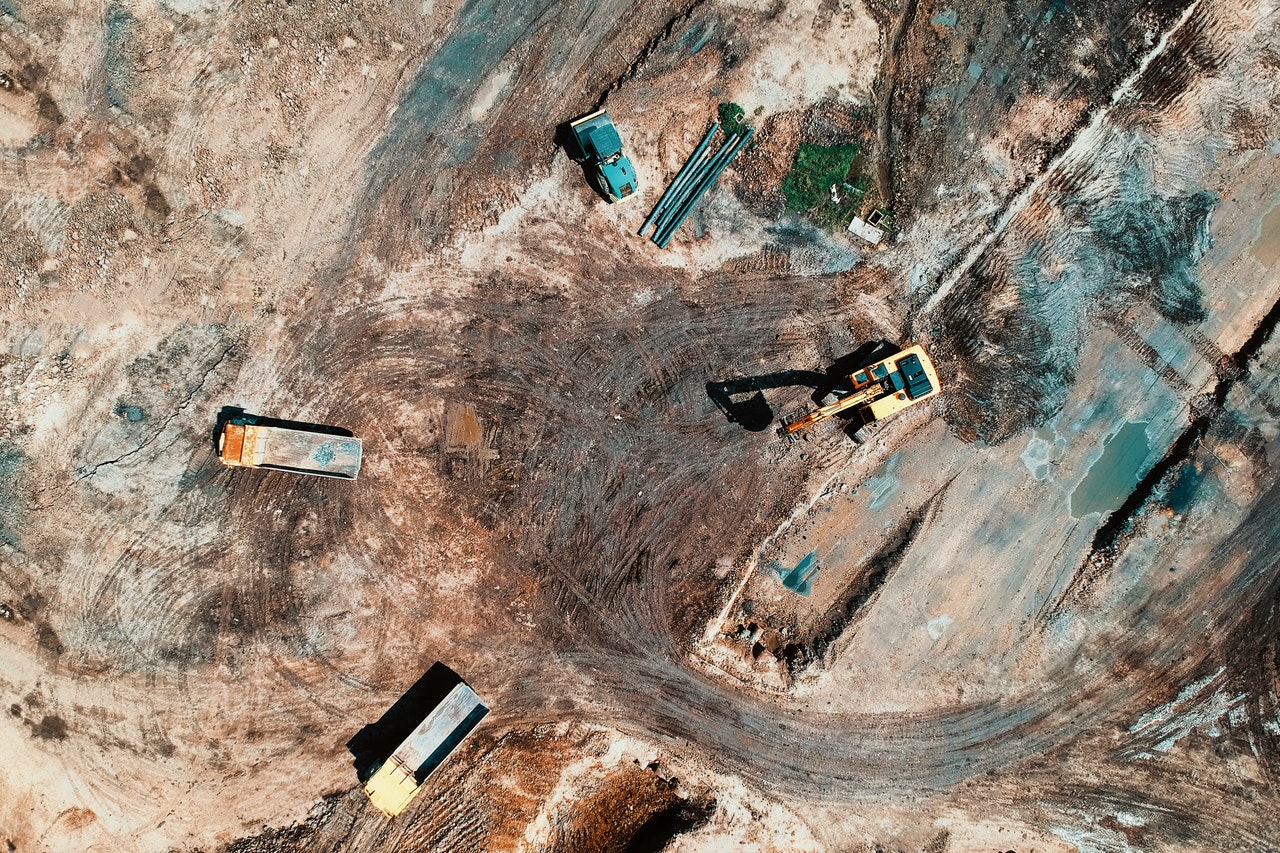 aerial view photography of utility vehicles on brown soil 1188553